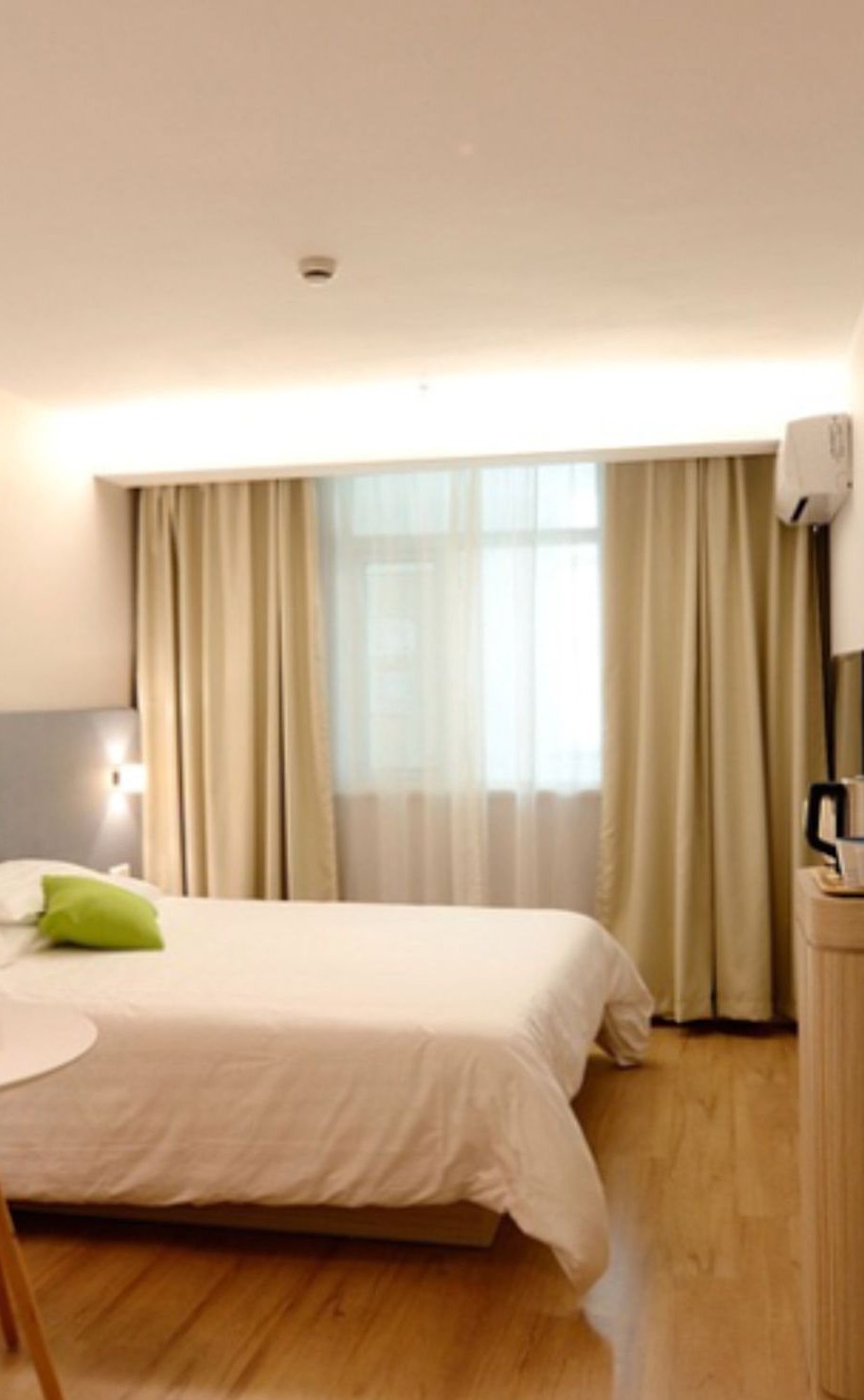 Hotel room with a bed and window view, ready to book